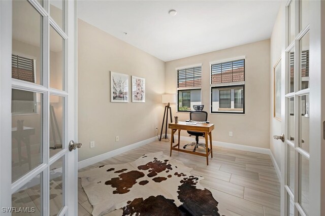 office area featuring french doors and light hardwood / wood-style floors