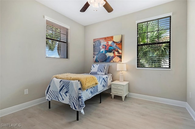 bedroom with light wood-type flooring and ceiling fan