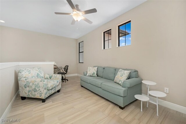 living room with light wood-type flooring and ceiling fan