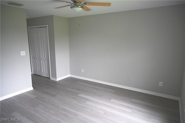 spare room featuring ceiling fan and hardwood / wood-style flooring