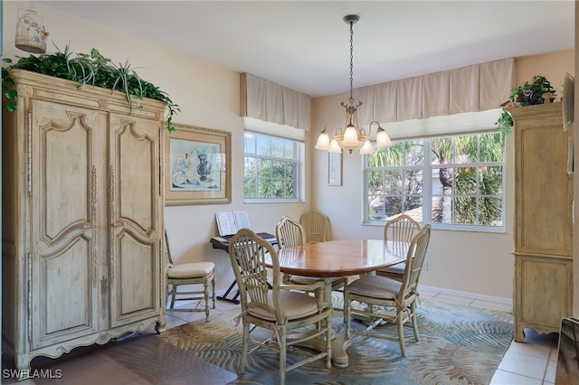 tiled dining area featuring a chandelier