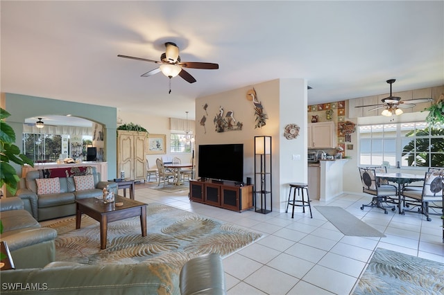 living room with light tile patterned flooring, plenty of natural light, and ceiling fan