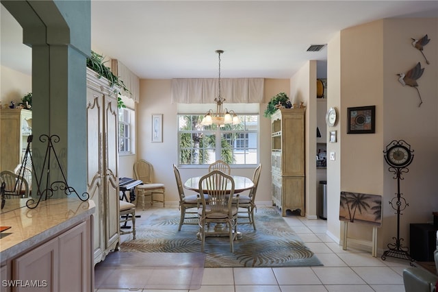 tiled dining area featuring an inviting chandelier