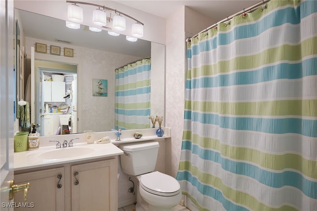 bathroom featuring toilet and vanity