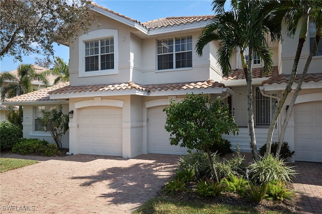 mediterranean / spanish home featuring a garage