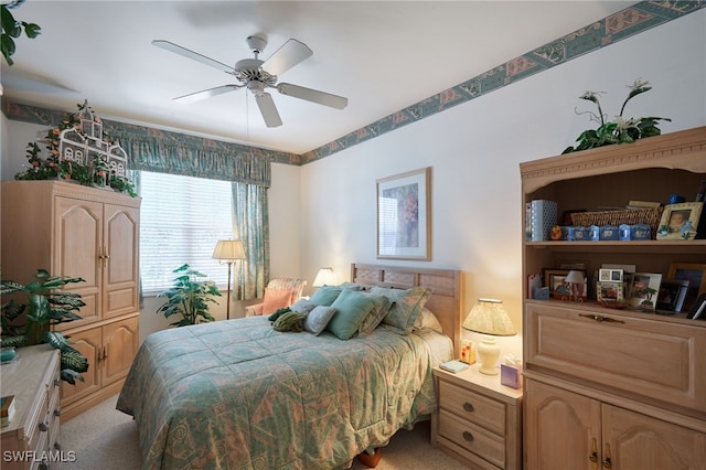 bedroom with light carpet and ceiling fan