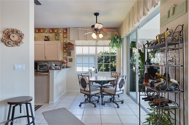 tiled dining room featuring ceiling fan and a wealth of natural light