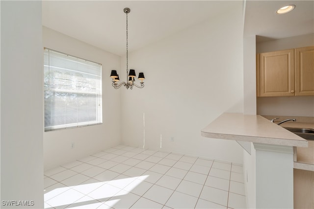 unfurnished dining area with a notable chandelier, sink, and light tile patterned floors