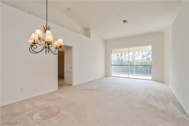 spare room with light carpet, an inviting chandelier, and vaulted ceiling