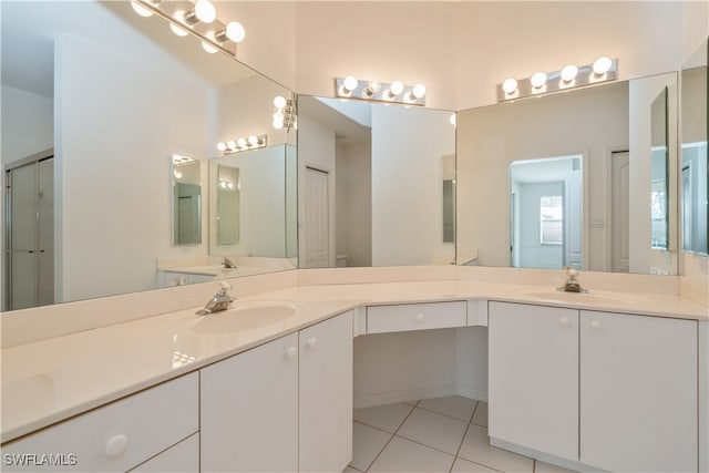 bathroom with vanity, toilet, tile patterned floors, and a shower with door