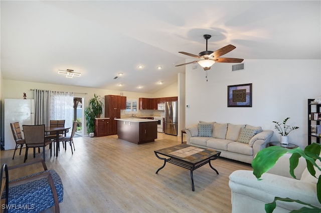 living room with lofted ceiling, light wood-type flooring, and ceiling fan