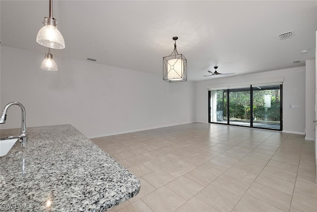 interior space featuring sink and ceiling fan