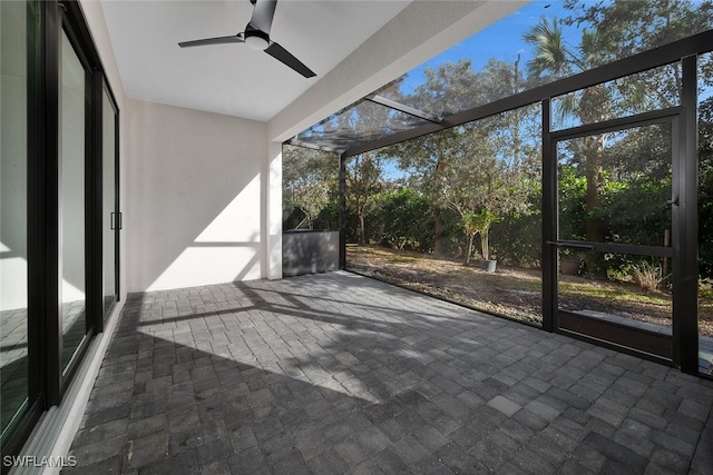 unfurnished sunroom with ceiling fan