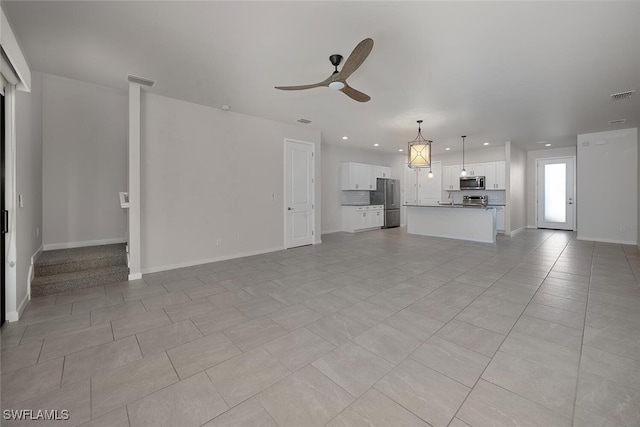 unfurnished living room featuring ceiling fan and light tile patterned floors