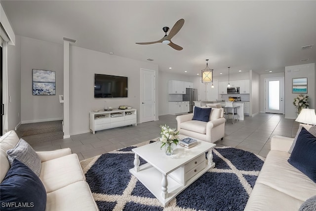 tiled living room with ceiling fan