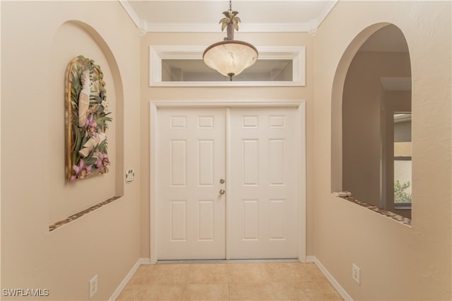 interior space with crown molding and light tile patterned floors