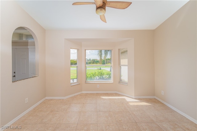 unfurnished room with ceiling fan and light tile patterned flooring