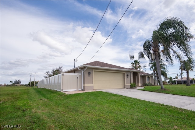 view of front of property with a front lawn and a garage