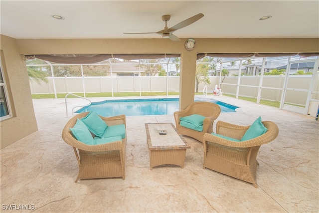 view of pool featuring ceiling fan, a patio, and a lanai