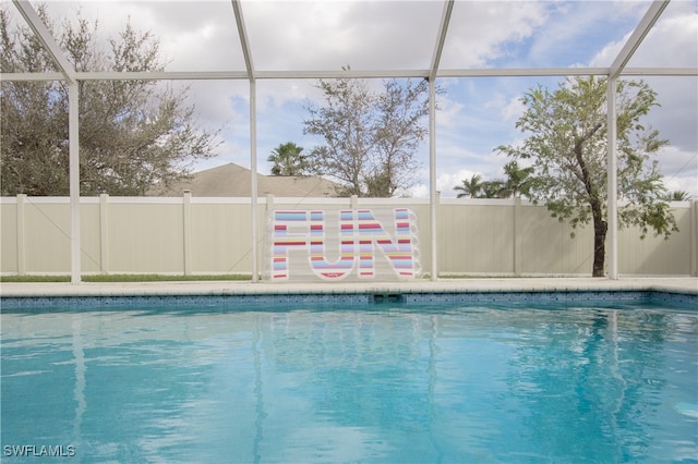 view of swimming pool with glass enclosure