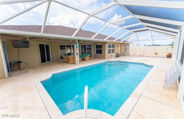 view of pool featuring a lanai, a patio area, and ceiling fan