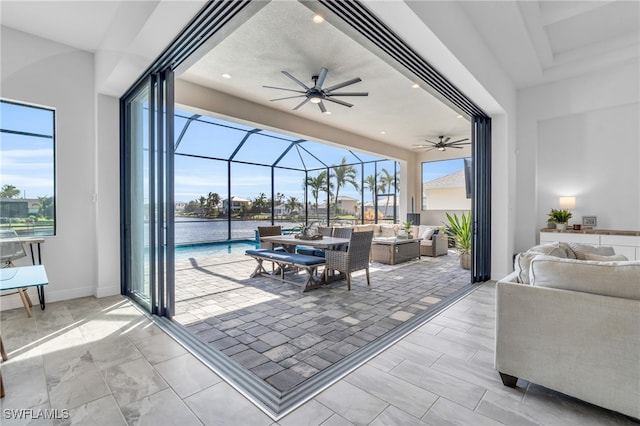 view of patio / terrace with an outdoor living space, a lanai, and ceiling fan