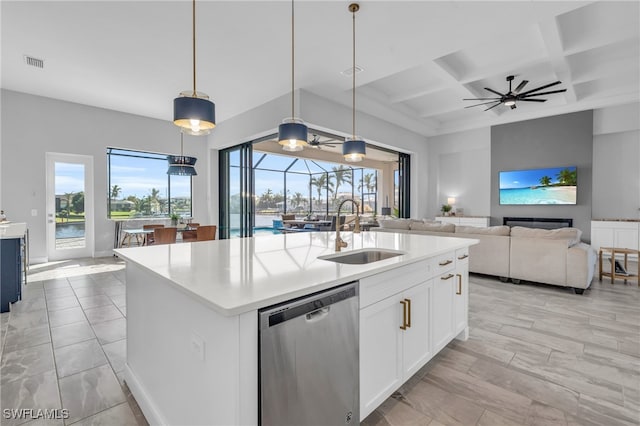 kitchen with a kitchen island with sink, stainless steel dishwasher, sink, decorative light fixtures, and coffered ceiling