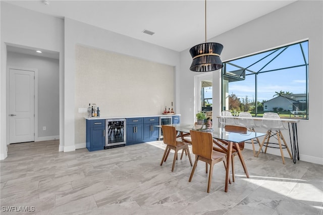 dining room with bar and beverage cooler