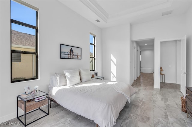 bedroom featuring ornamental molding and a tray ceiling