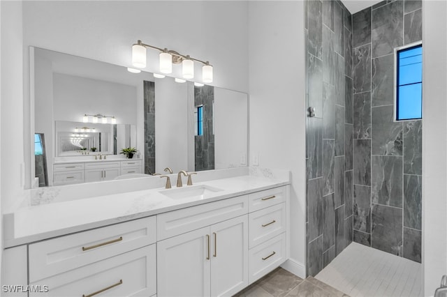 bathroom with vanity and a tile shower