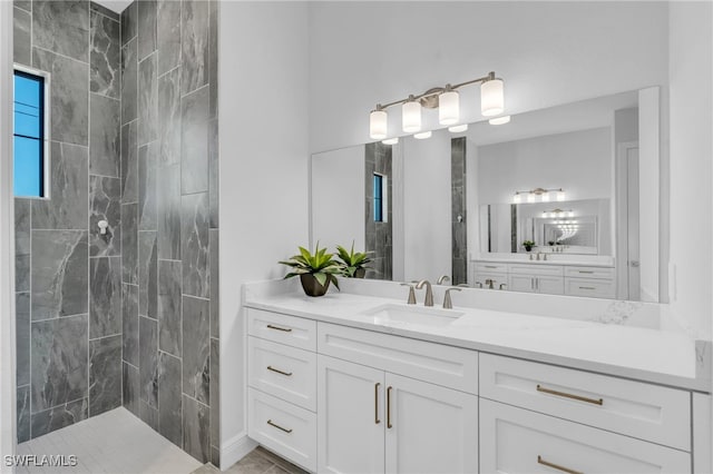 bathroom featuring vanity and a tile shower