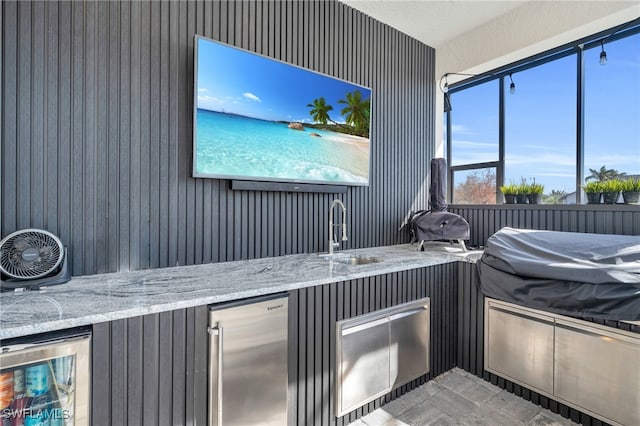 view of patio with sink and beverage cooler