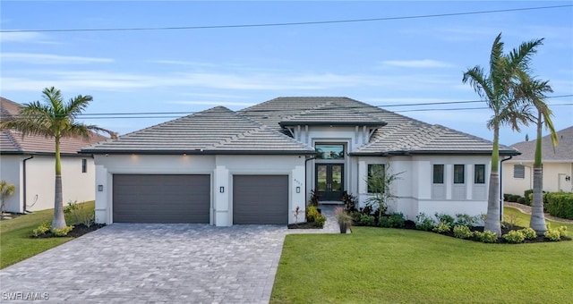 view of front of property with a garage and a front lawn