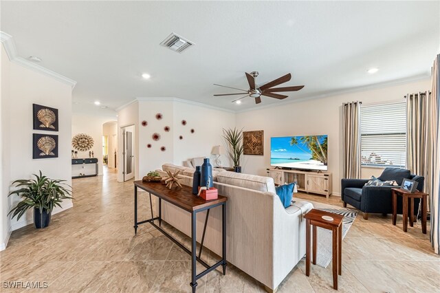 living room with ornamental molding and ceiling fan