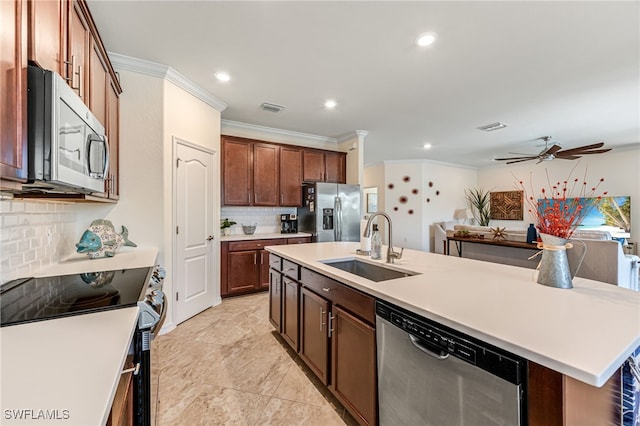 kitchen with visible vents, an island with sink, a sink, appliances with stainless steel finishes, and light countertops