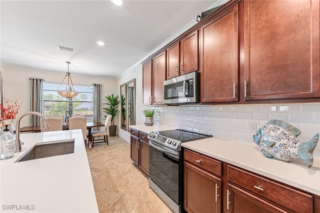 kitchen with sink, crown molding, stainless steel appliances, tasteful backsplash, and decorative light fixtures