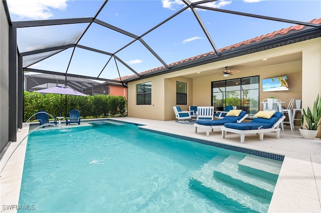 pool with a patio area, glass enclosure, and ceiling fan