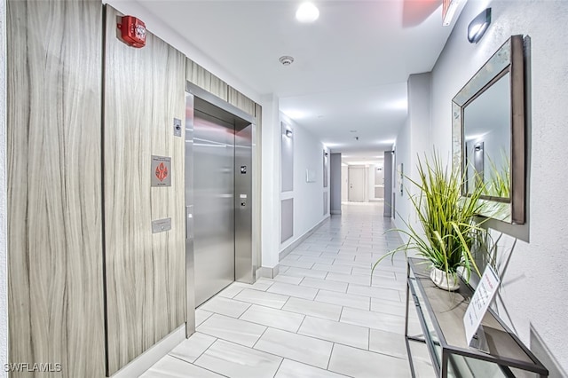 11701 Olivetti Ln Unit 307, Fort Myers, FL 33908 - hall featuring elevator and tile patterned flooring