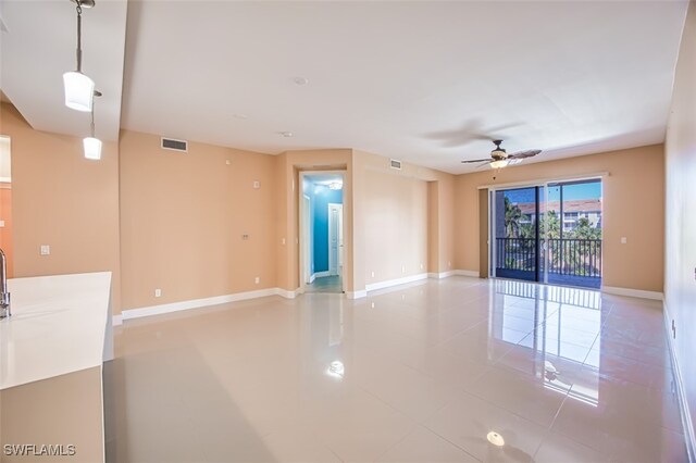 11701 Olivetti Ln Unit 307, Fort Myers, FL 33908 - empty room with visible vents, a ceiling fan, baseboards, and light tile patterned flooring