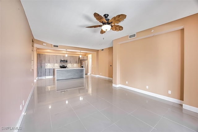 unfurnished living room with ceiling fan and light tile patterned floors