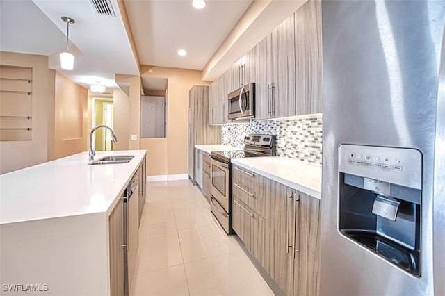 11701 Olivetti Ln Unit 307, Fort Myers, FL 33908 - kitchen featuring a sink, light countertops, stainless steel appliances, decorative backsplash, and visible vents