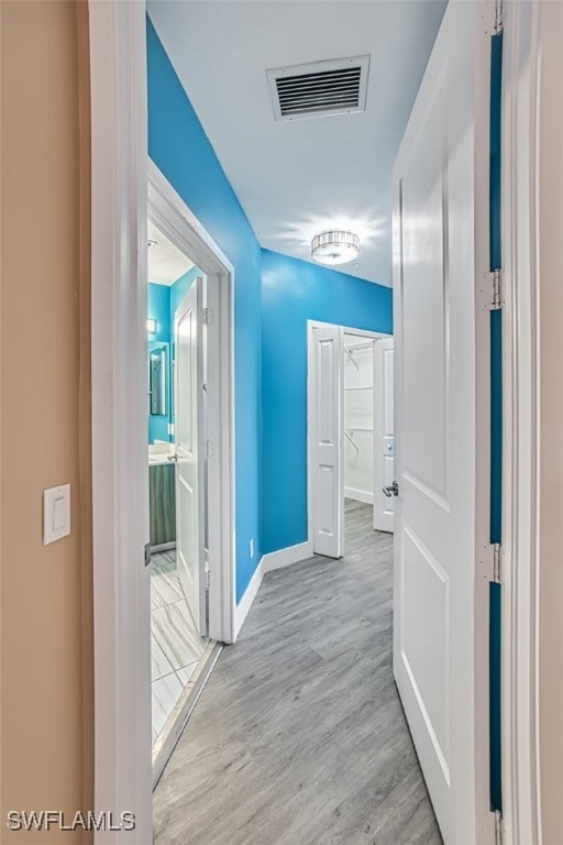 hallway with light wood-type flooring