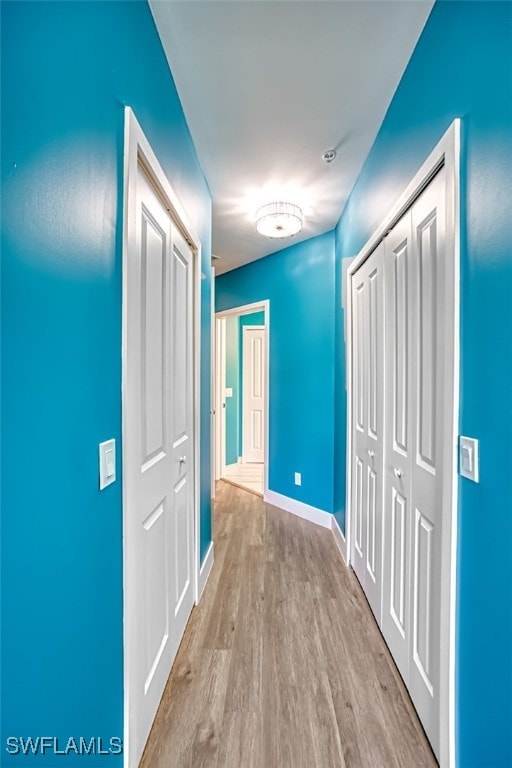 11701 Olivetti Ln Unit 307, Fort Myers, FL 33908 - hall with baseboards and wood finished floors