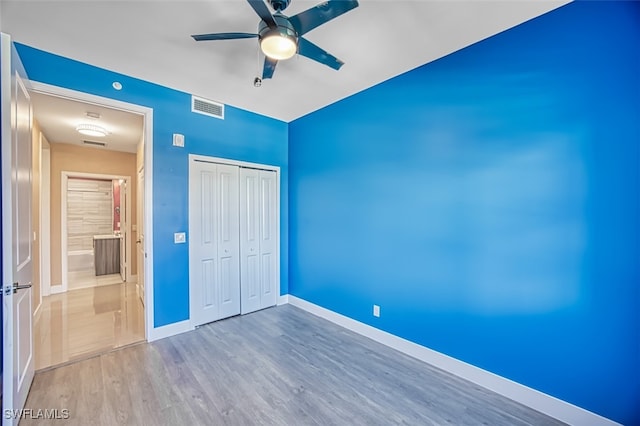 11701 Olivetti Ln Unit 307, Fort Myers, FL 33908 - unfurnished bedroom featuring visible vents, baseboards, wood finished floors, and a closet