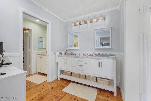 bathroom featuring vanity, hardwood / wood-style floors, and crown molding