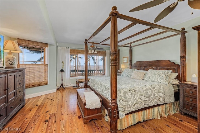 bedroom featuring multiple windows, light hardwood / wood-style flooring, and access to outside