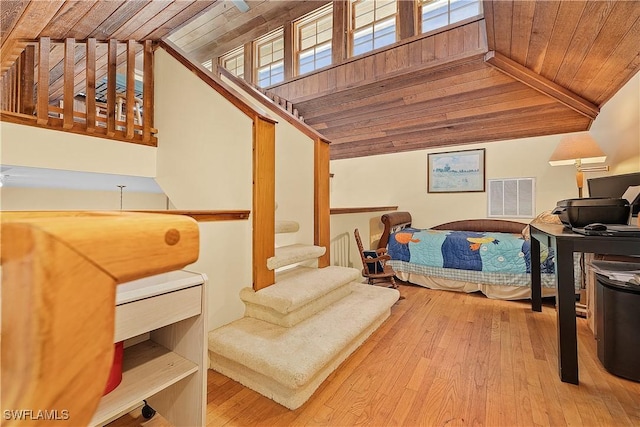 interior space with lofted ceiling with beams, wood ceiling, and light hardwood / wood-style floors