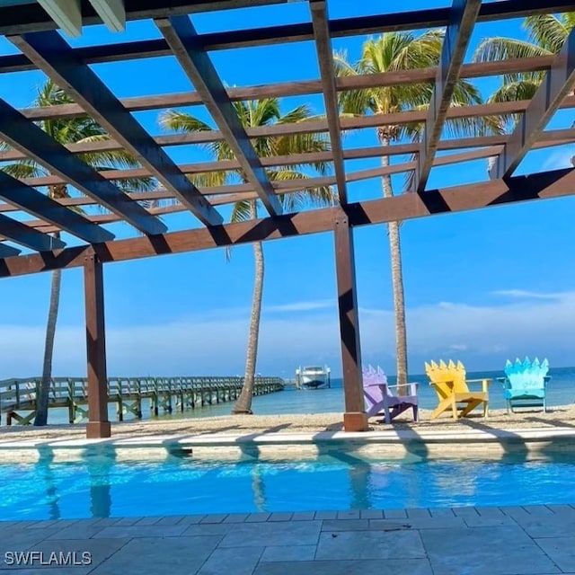 view of swimming pool featuring a water view