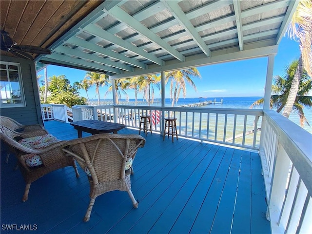 wooden terrace featuring a water view and ceiling fan