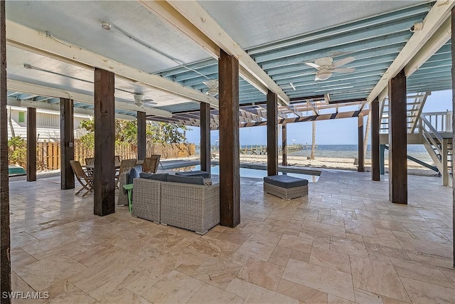 view of patio featuring a water view, ceiling fan, and a pergola